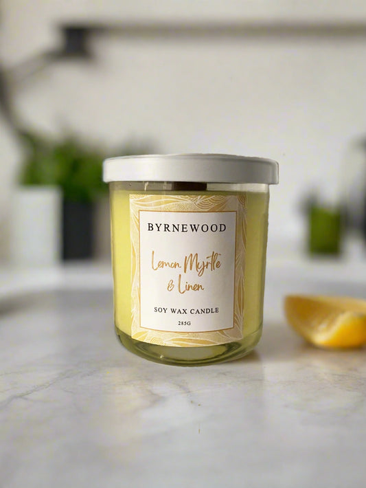 Byrnewood Yellow Lemon Myrtle & Linen handcrafted scented soy wax candle with a wood wick, poured into a large 285g luxury glass vessel – made on the Gold Coast, Australia for an eco-friendly, clean-burning, and beautifully fragranced experience.
